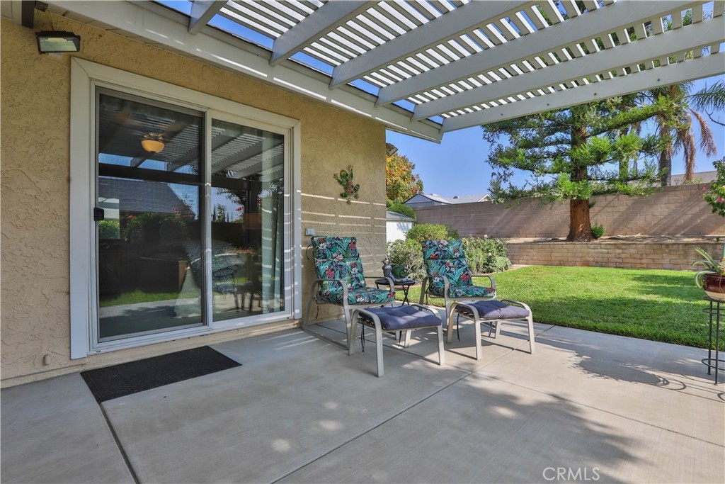 7241 Marine Avenue Rancho Cucamonga, CA 91701 - Photo 32 of 48 a view of a patio with a table and chairs and potted plants