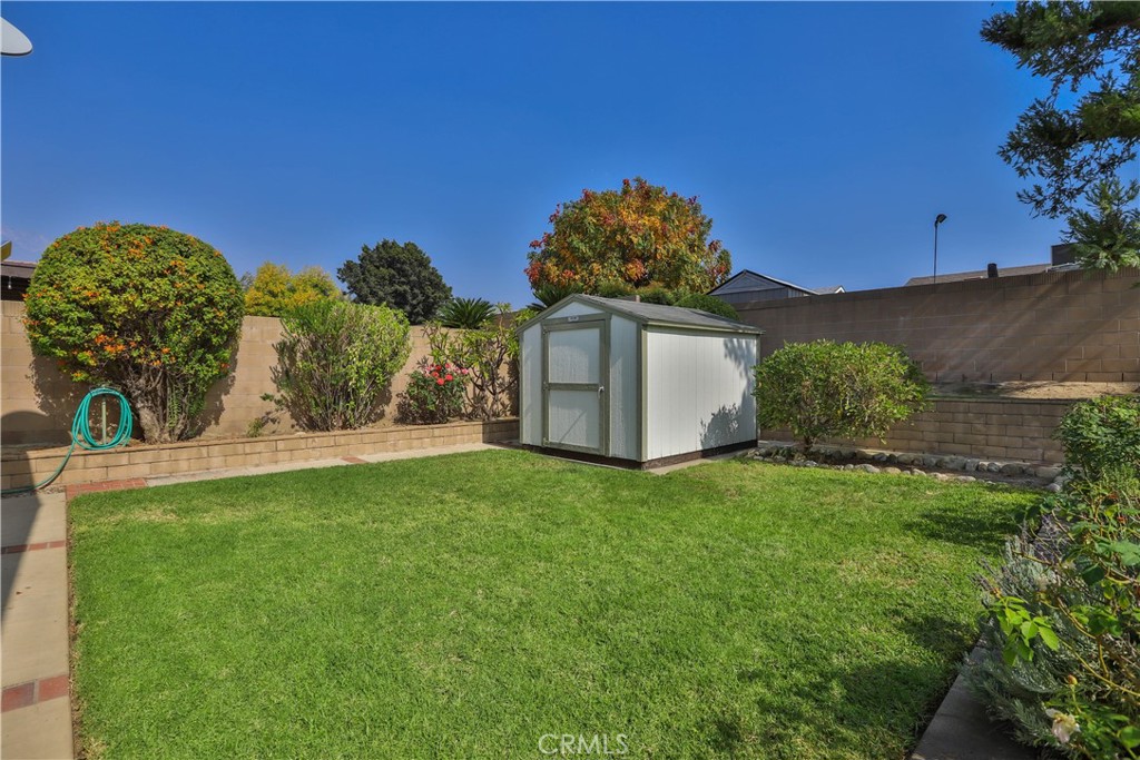 7241 Marine Avenue Rancho Cucamonga, CA 91701 - Photo 36 of 48 a view of a backyard with potted plants and large tree