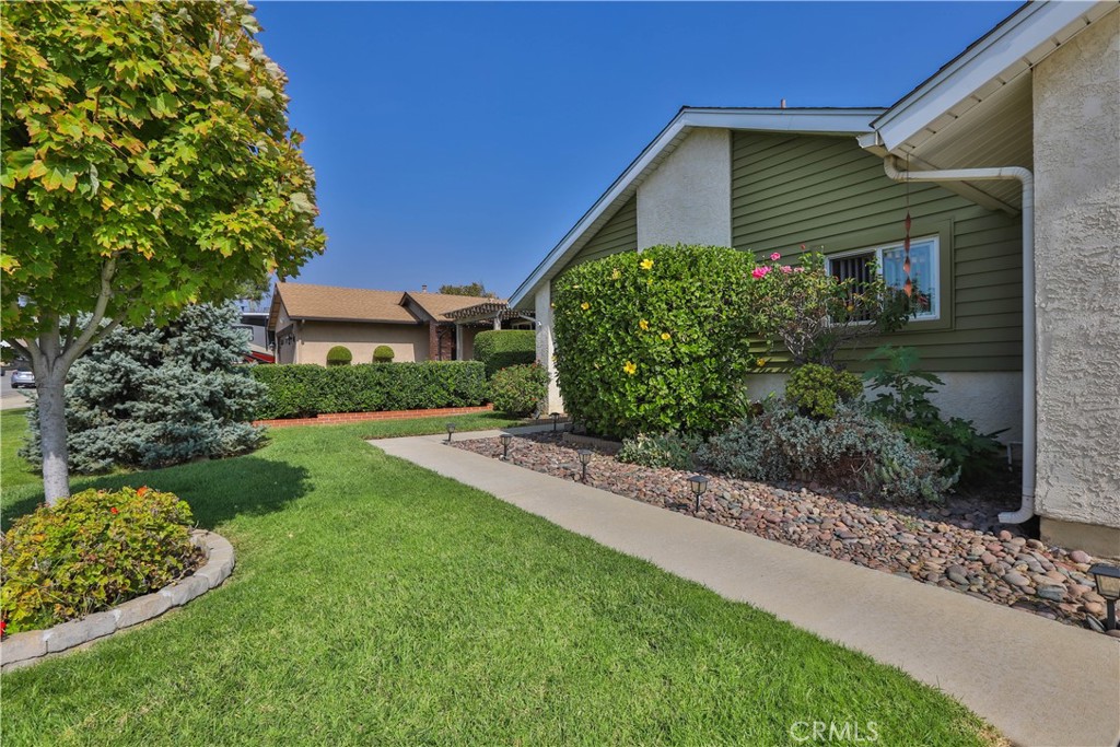 7241 Marine Avenue Rancho Cucamonga, CA 91701 - Photo 5 of 48 a front view of a house with a yard and potted plants