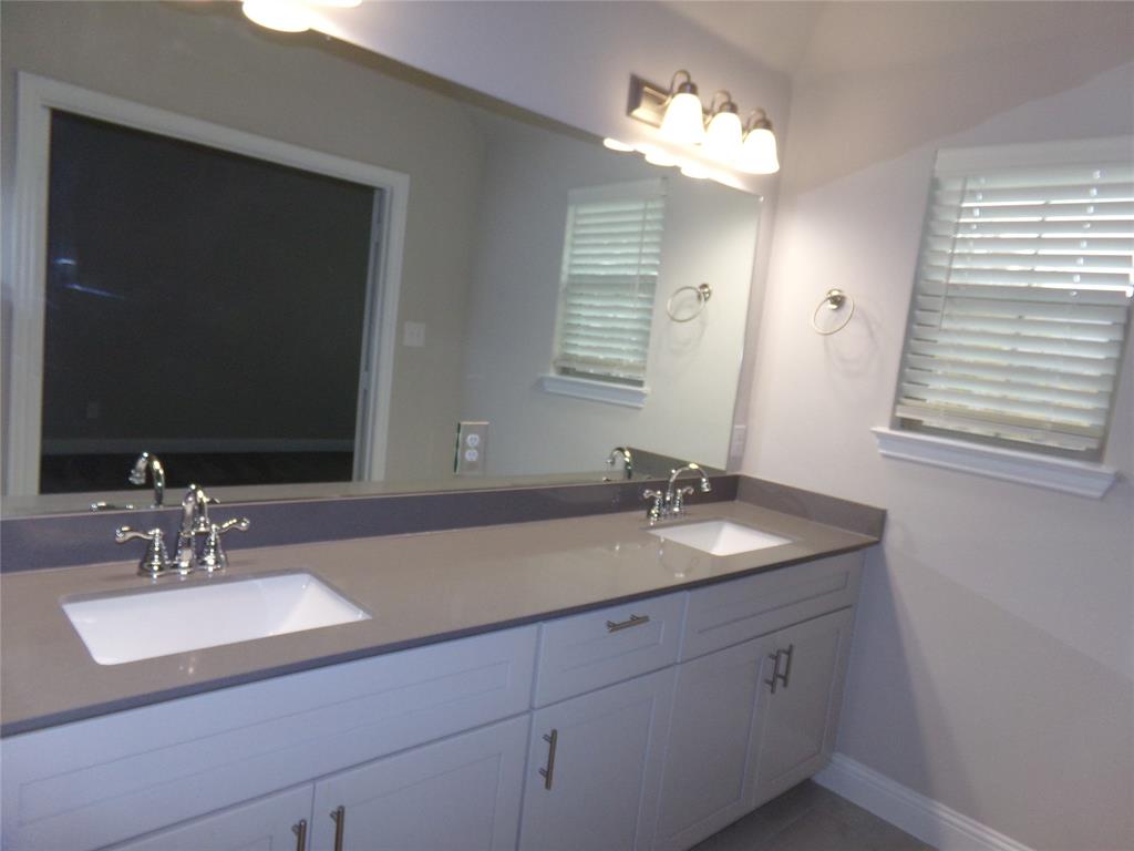 1748 Redding Street Allen, TX 75002 - Photo 18 of 33 Bathroom with double vanity and baseboards