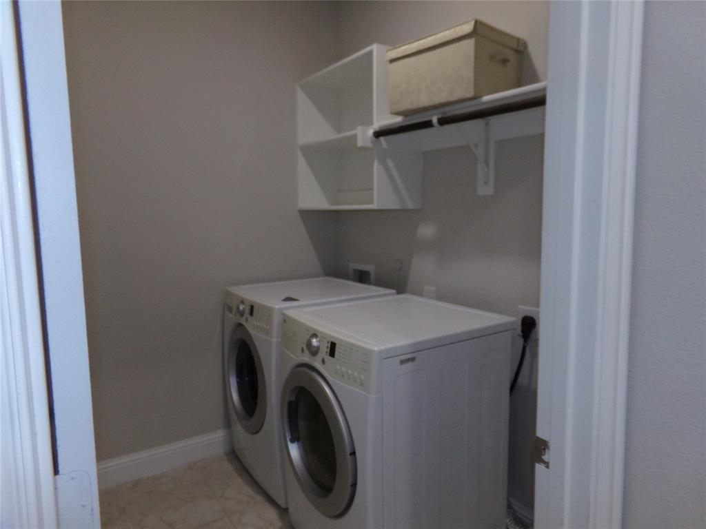 1748 Redding Street Allen, TX 75002 - Photo 19 of 33 Laundry room featuring washer and clothes dryer and baseboards