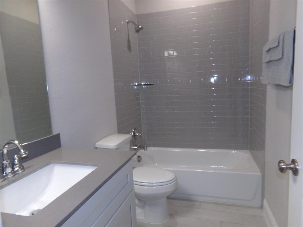 1748 Redding Street Allen, TX 75002 - Photo 20 of 33 a bathroom with a granite countertop sink a toilet and shower