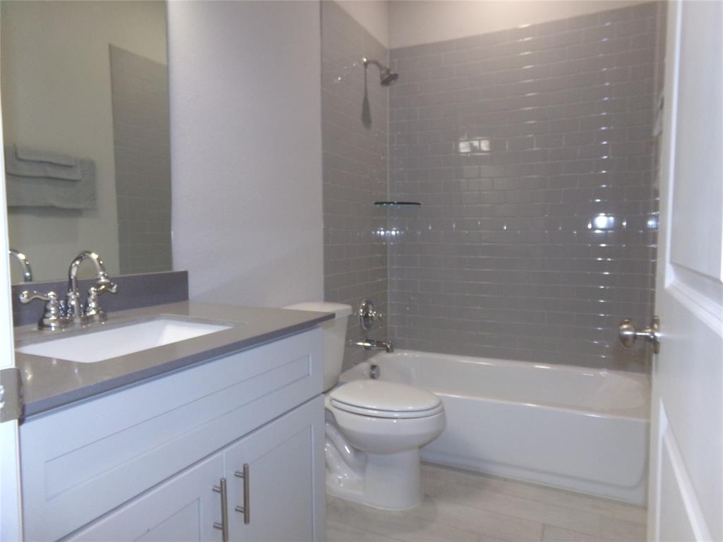 1748 Redding Street Allen, TX 75002 - Photo 22 of 33 Bathroom featuring vanity, washtub / shower combination, and light wood finished floors
