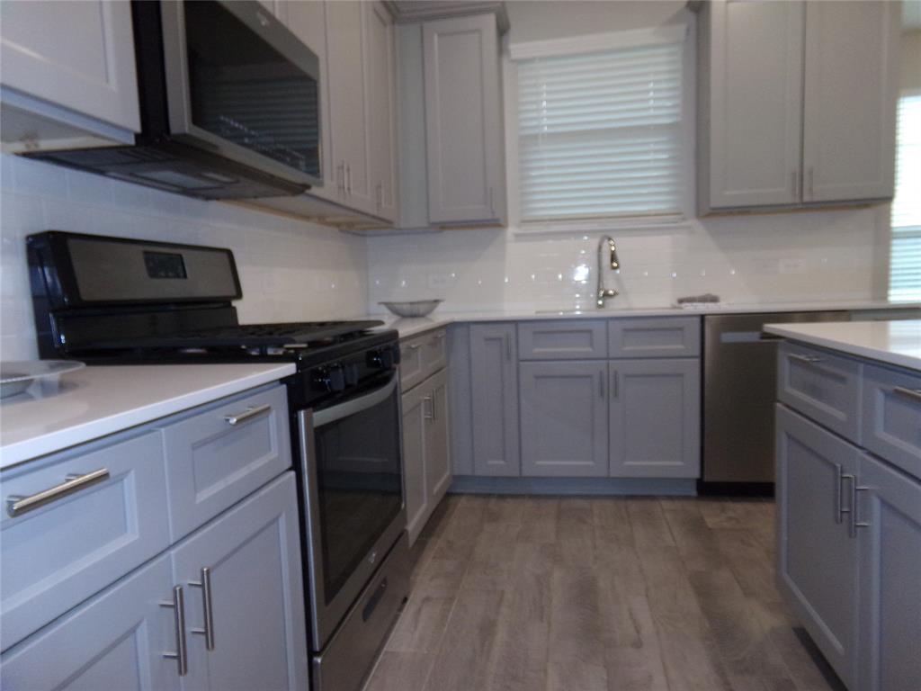 1748 Redding Street Allen, TX 75002 - Photo 5 of 33 a kitchen with stainless steel appliances granite countertop a sink stove top oven and cabinets