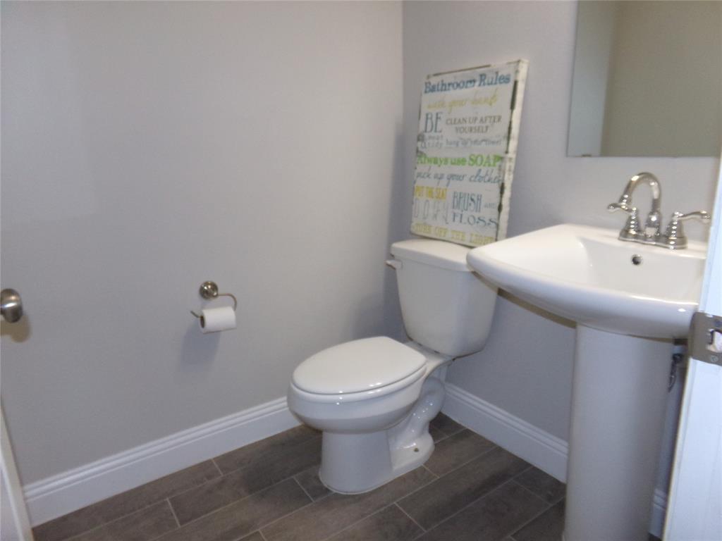 1748 Redding Street Allen, TX 75002 - Photo 9 of 33 Half bathroom featuring baseboards and wood tiled floors located downstairs