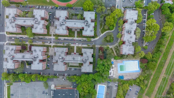 an aerial view of a house with a swimming pool outdoor seating and yard
