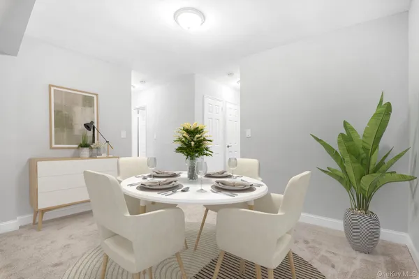 a dining room with furniture potted plants and wooden floor
