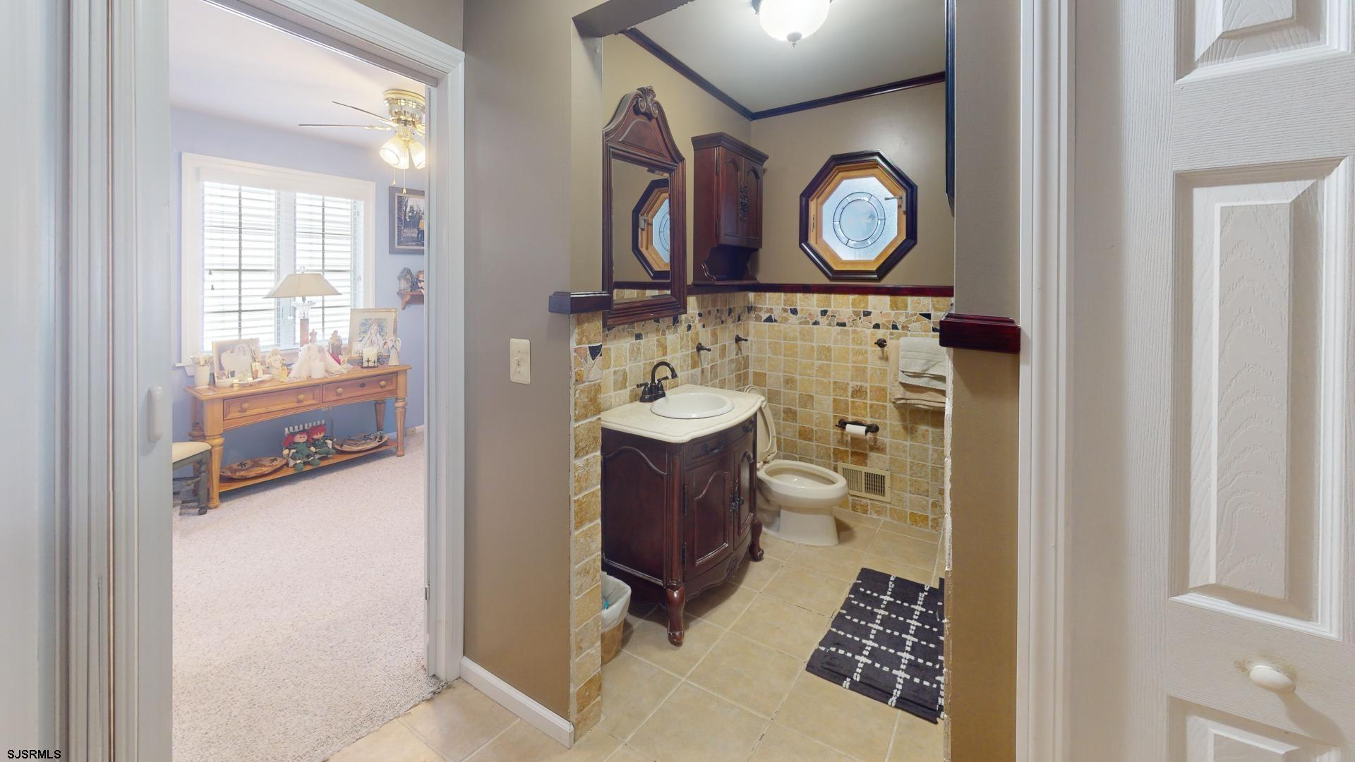 228 Marlin Road Absecon, NJ 08201 - Photo 16 of 24 a bathroom with a sink and a mirror