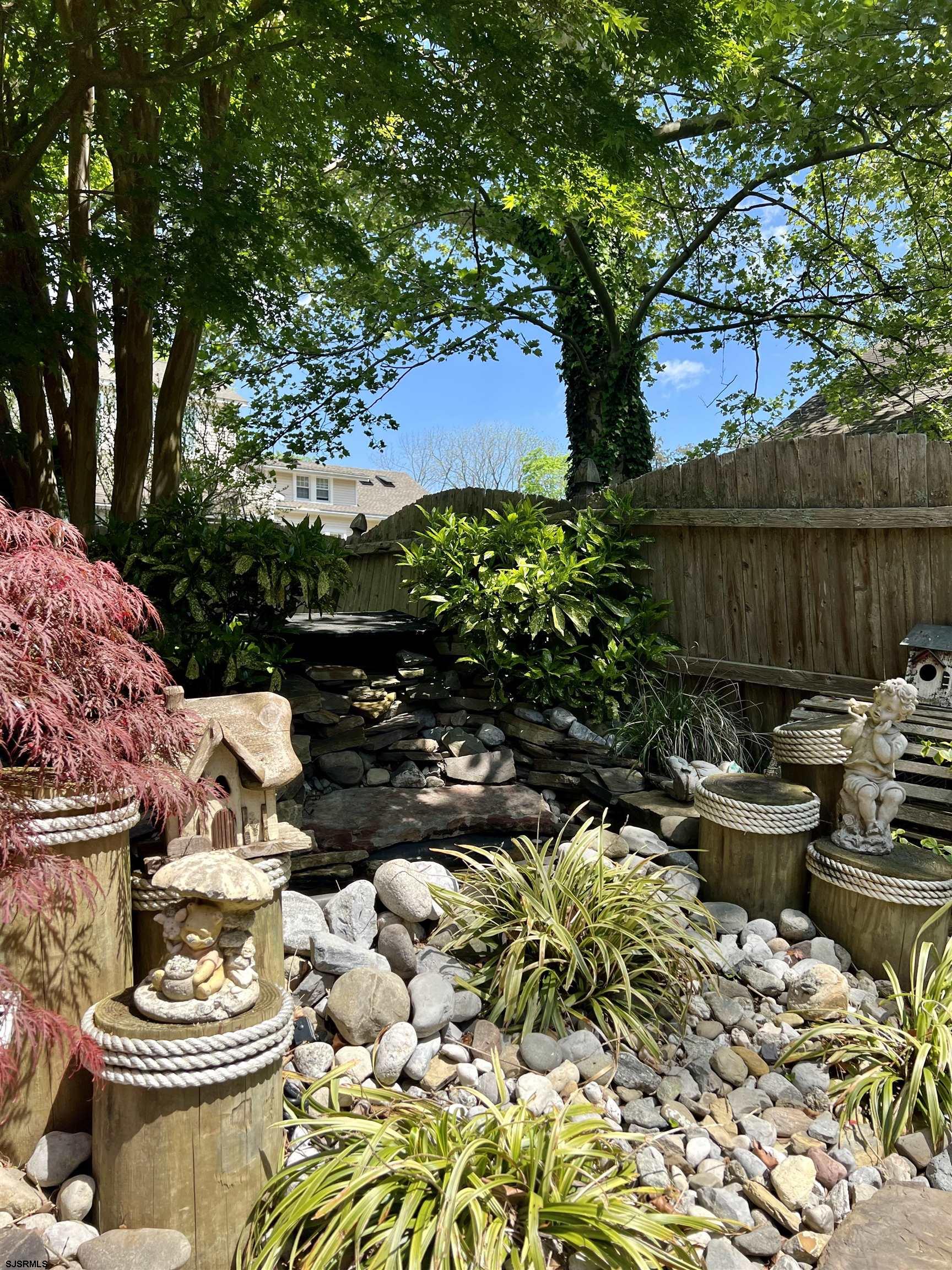 228 Marlin Road Absecon, NJ 08201 - Photo 22 of 24 a view of a backyard with plants and a patio