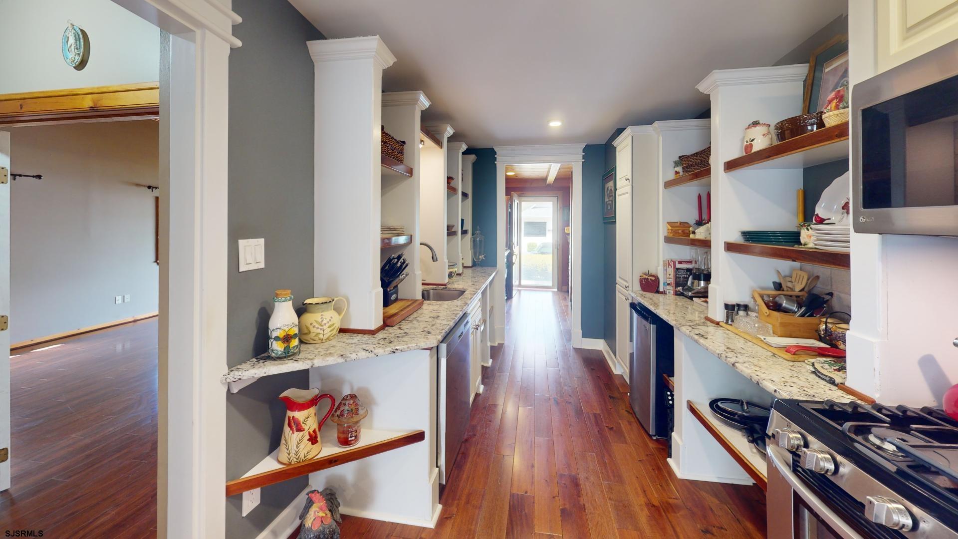 228 Marlin Road Absecon, NJ 08201 - Photo 4 of 24 a kitchen with stainless steel appliances granite countertop a lot of counter space and wooden floor