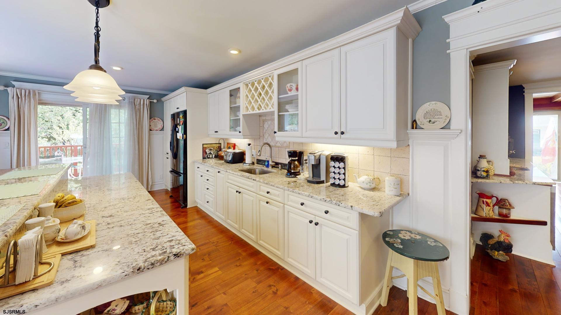 228 Marlin Road Absecon, NJ 08201 - Photo 8 of 24 a kitchen with stainless steel appliances granite countertop a sink and a refrigerator