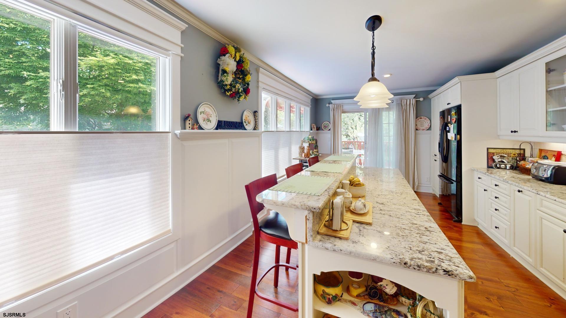 228 Marlin Road Absecon, NJ 08201 - Photo 9 of 24 a view of a dining room and livingroom with furniture wooden floor a chandelier