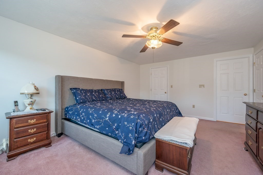 85 Elyse Road Mansfield, MA 02048 - Photo 14 of 30 a bedroom with a bed and a chandelier