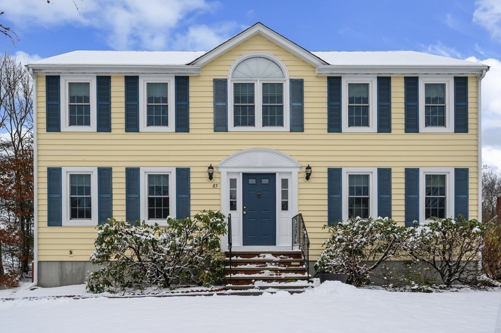 85 Elyse Road Mansfield, MA 02048 - Photo 3 of 30 a view of a brick house with large windows and flower plants