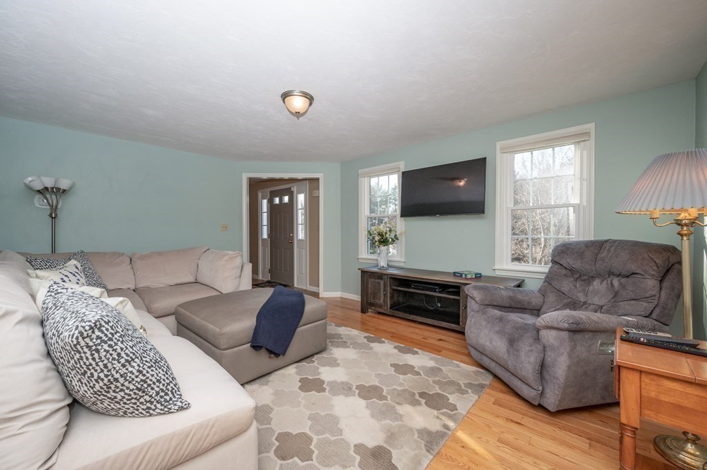 85 Elyse Road Mansfield, MA 02048 - Photo 5 of 30 a living room with furniture and a flat screen tv