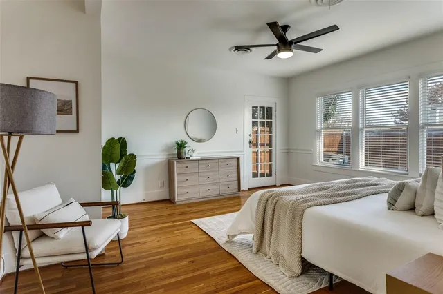 a bedroom with a bed a dresser and chair