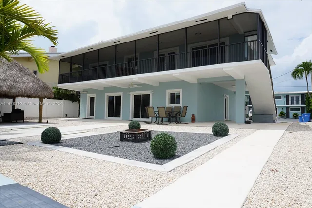 a view of a swimming pool with furniture