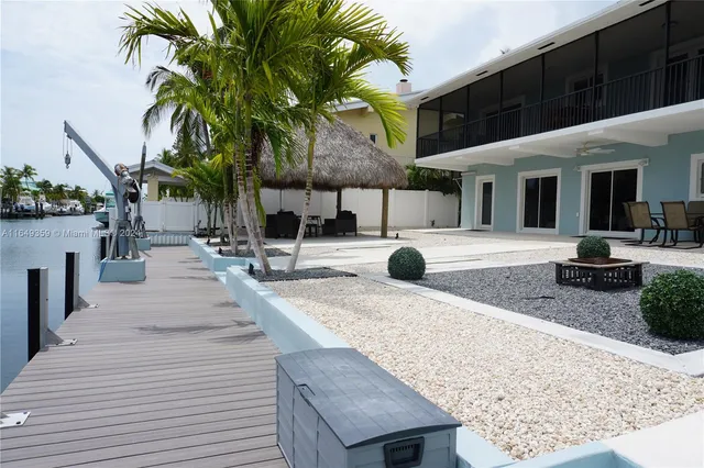 a view of a backyard patio and swimming pool