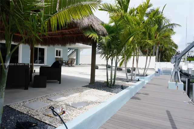 a view of a porch with furniture and floor to ceiling window