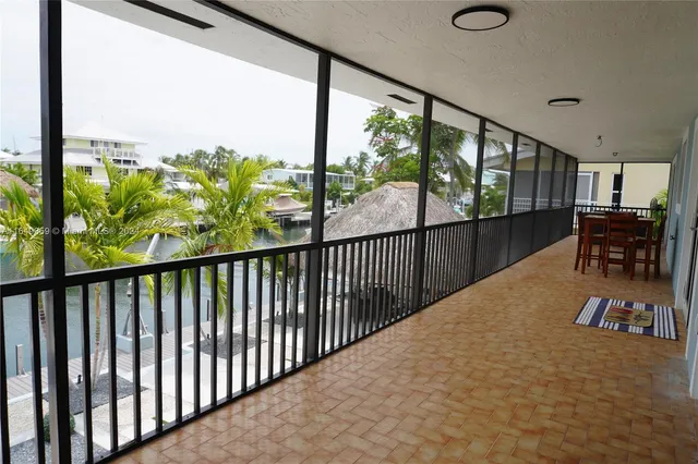 a view of swimming pool with a table and chairs
