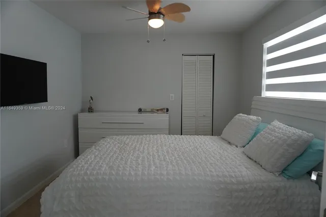 a bedroom with a bed and window