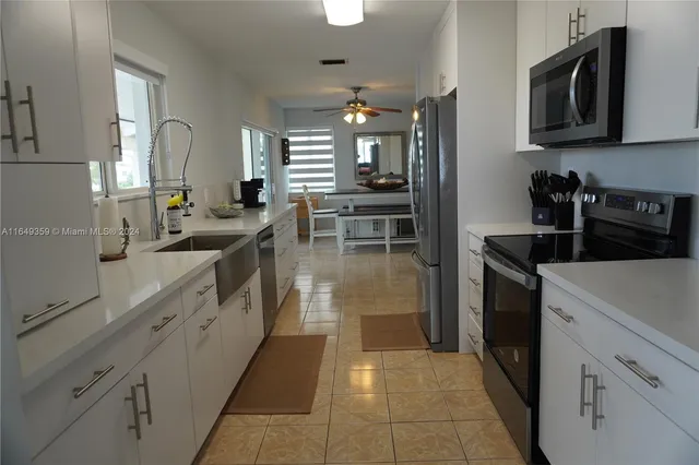 a kitchen with a refrigerator and a sink