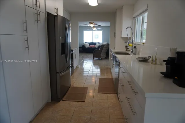a kitchen with a refrigerator stove and microwave