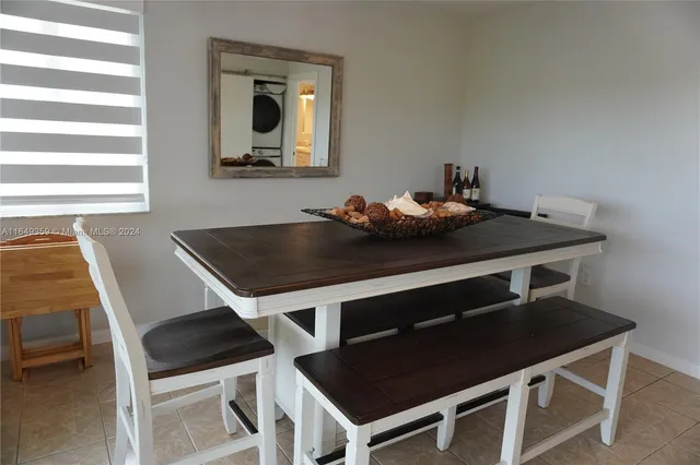 a bathroom with a granite countertop sink a toilet a mirror and shower