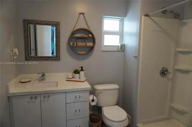 a living room with furniture a flat screen tv and a large window