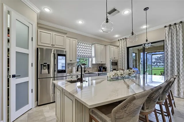 a bedroom with a large bed and a chandelier
