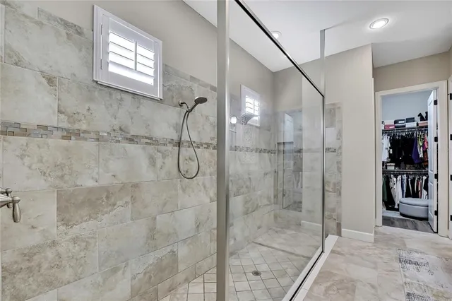 a living room with patio furniture and a floor to ceiling window