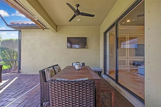 a view of a house with a yard and palm trees