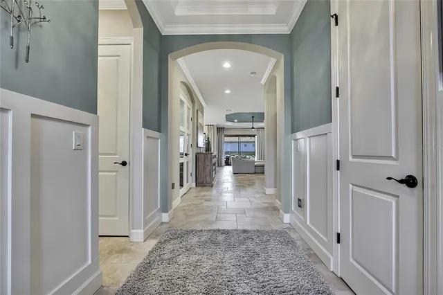 a large living room with stainless steel appliances granite countertop couches a fireplace and a flat screen television