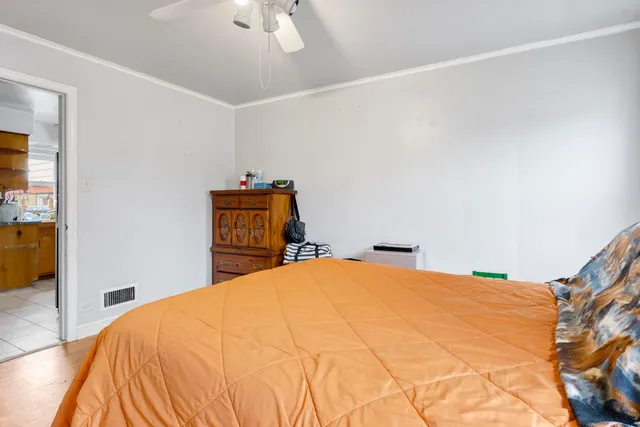 a bedroom with a bed and a dresser