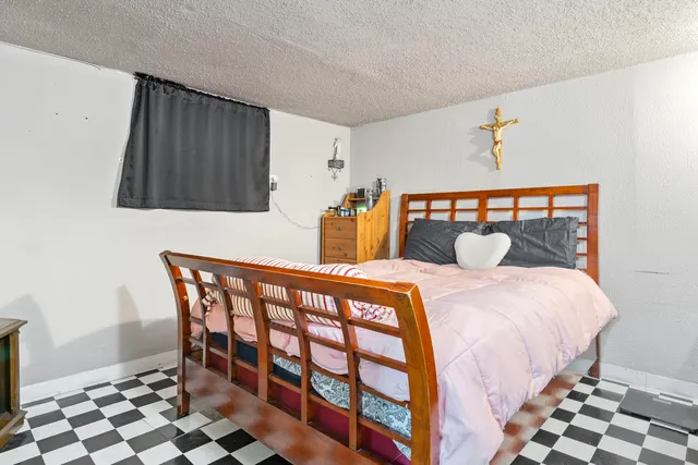 a bedroom with a bed and a chair