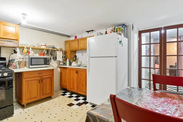 a kitchen with stainless steel appliances granite countertop a refrigerator and a stove