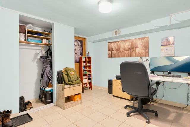 a view of a workspace with furniture and a window