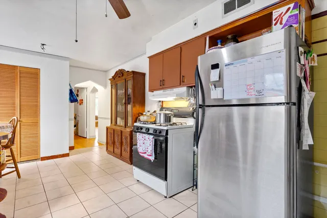a kitchen with stainless steel appliances granite countertop a refrigerator and a stove
