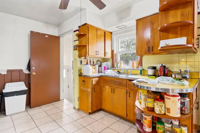 a dining hall with a sink and a refrigerator