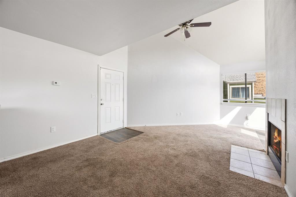 9837 Walnut Street, Unit S203 Dallas, TX 75243 - Photo 4 of 26 Inviting living area featuring a vaulted ceiling, a ceiling fan, and carpeted flooring