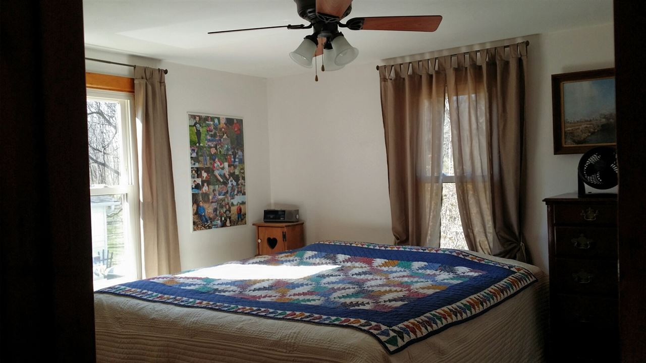 1714 North River Road Oregon, IL 61061 - Photo 2 of 8 a bed sitting in a bedroom next to a window