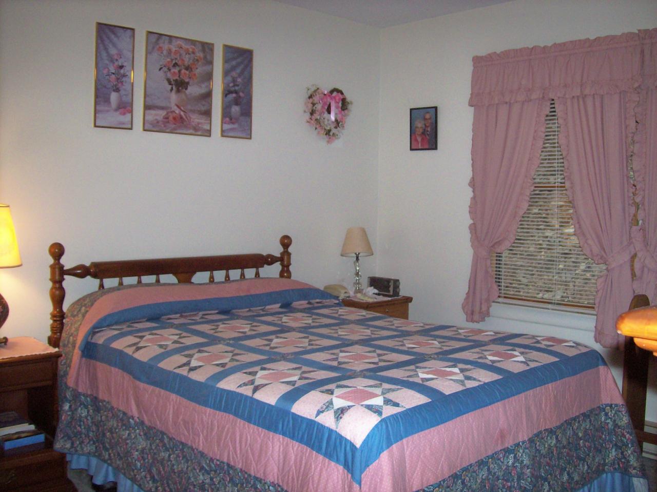 606 Frailey Road Stroudsburg, PA 18360 - Photo 8 of 11 a bed sitting in a bedroom next to a window