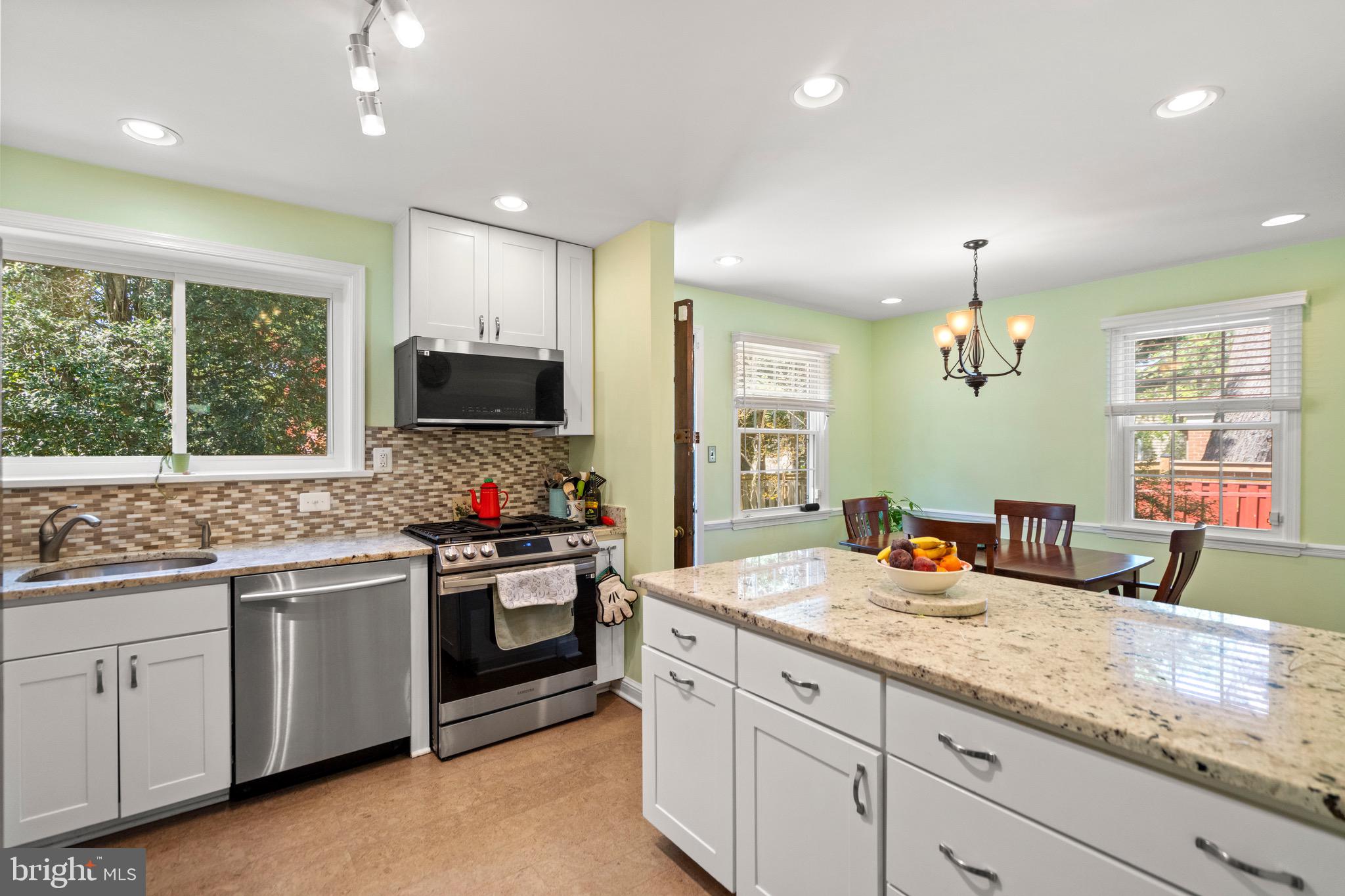 6110 Dorchester Street Springfield, VA 22150 - Photo 18 of 38 a kitchen with stainless steel appliances granite countertop a stove and a sink