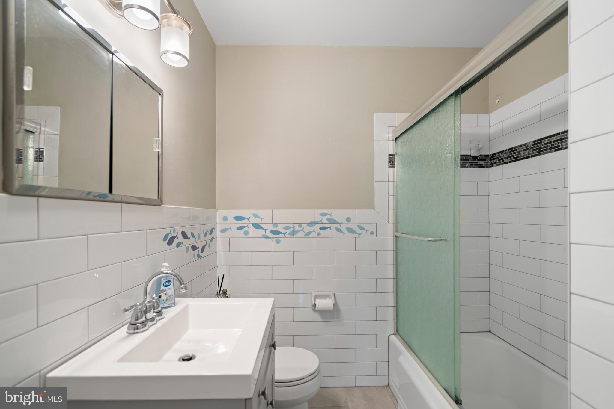 6110 Dorchester Street Springfield, VA 22150 - Photo 3 of 38 a bathroom with a sink a toilet and shower