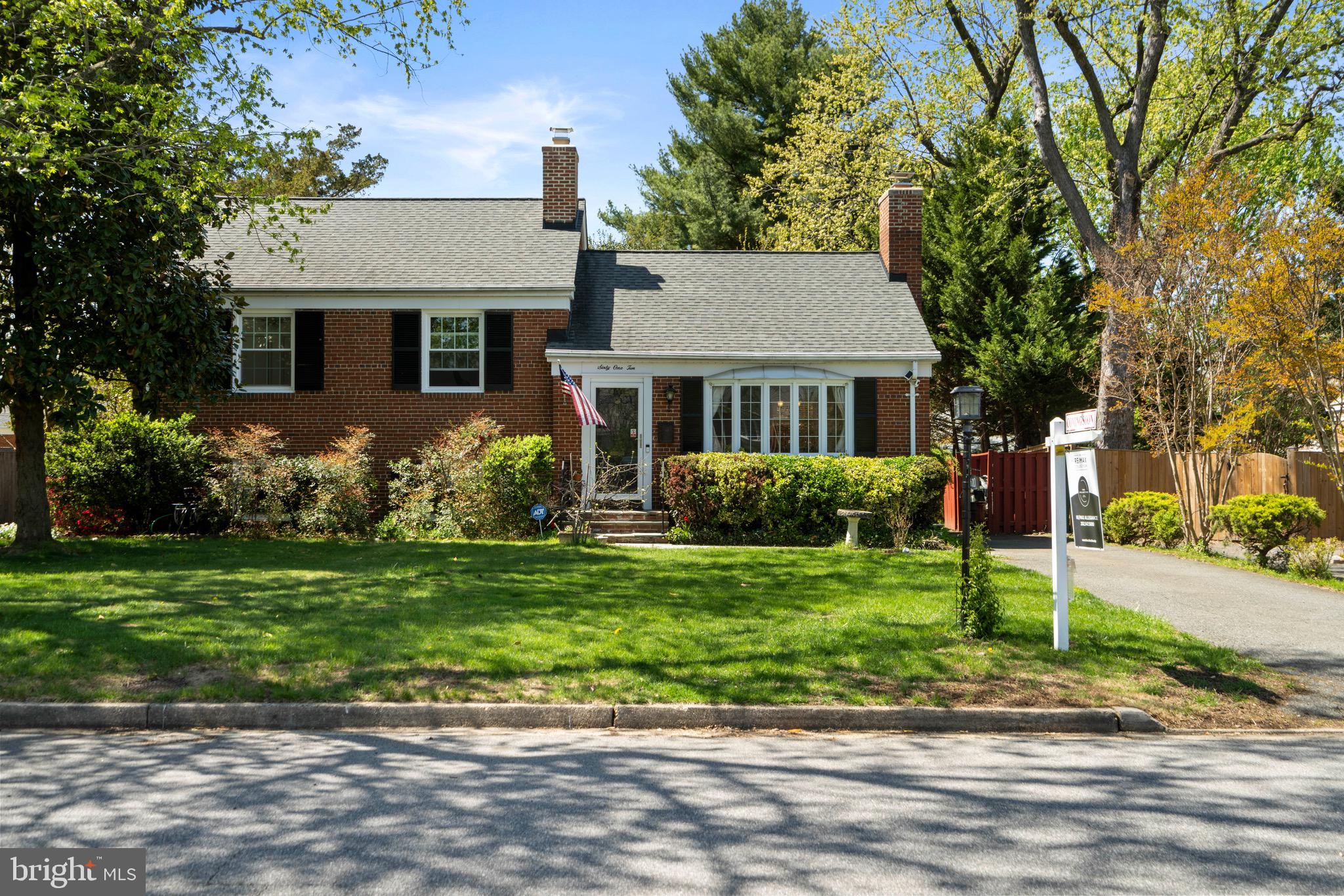 6110 Dorchester Street Springfield, VA 22150 - Photo 37 of 38 a front view of a house with a yard and potted plants