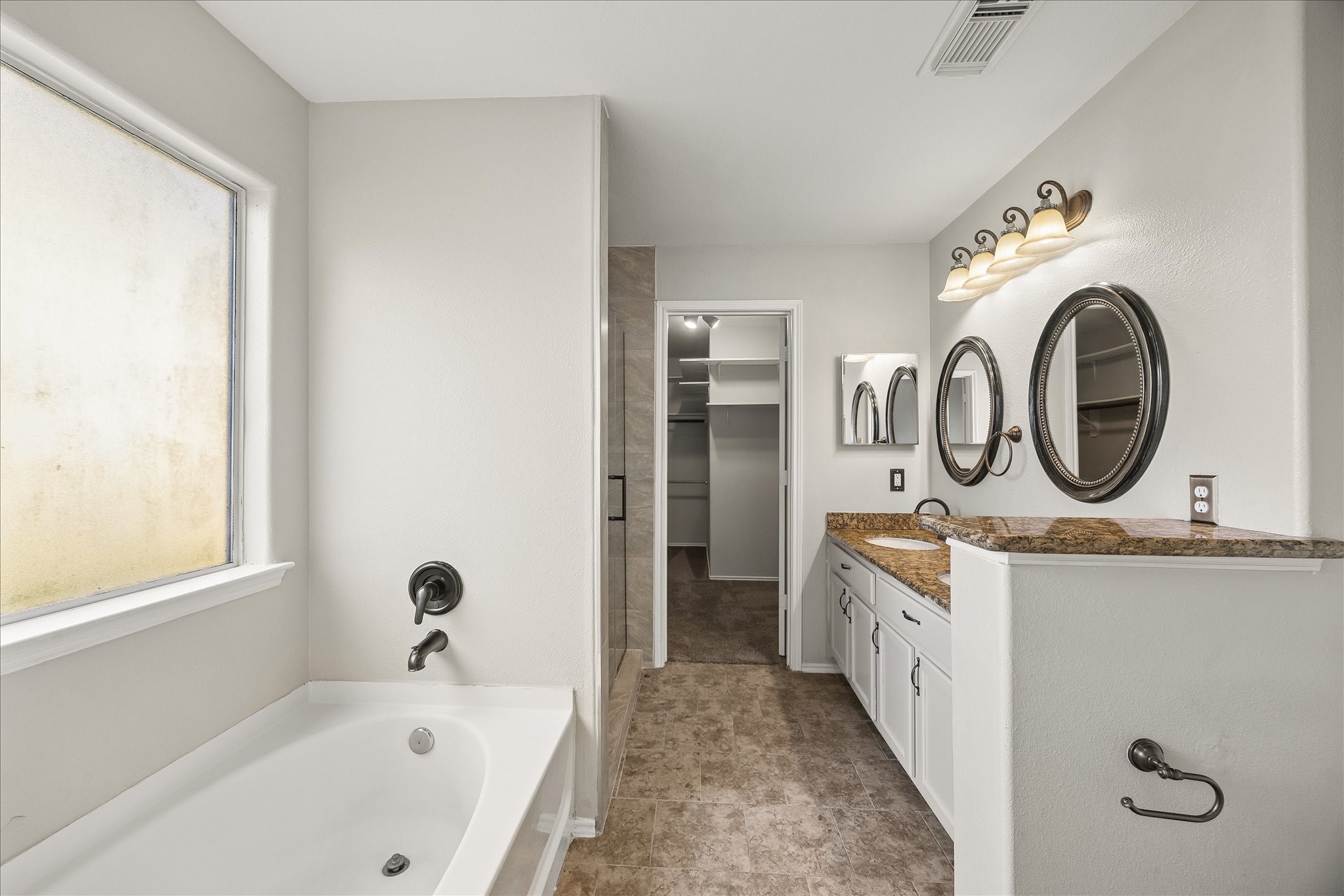 223 Sunset Colony Drive Rosharon, TX 77583 - Photo 19 of 50 Enjoy a daily dose of luxury in this private ensuite with a deep soaking tub, separate walk-in shower, dual sink vanity and massive walk-in closet.