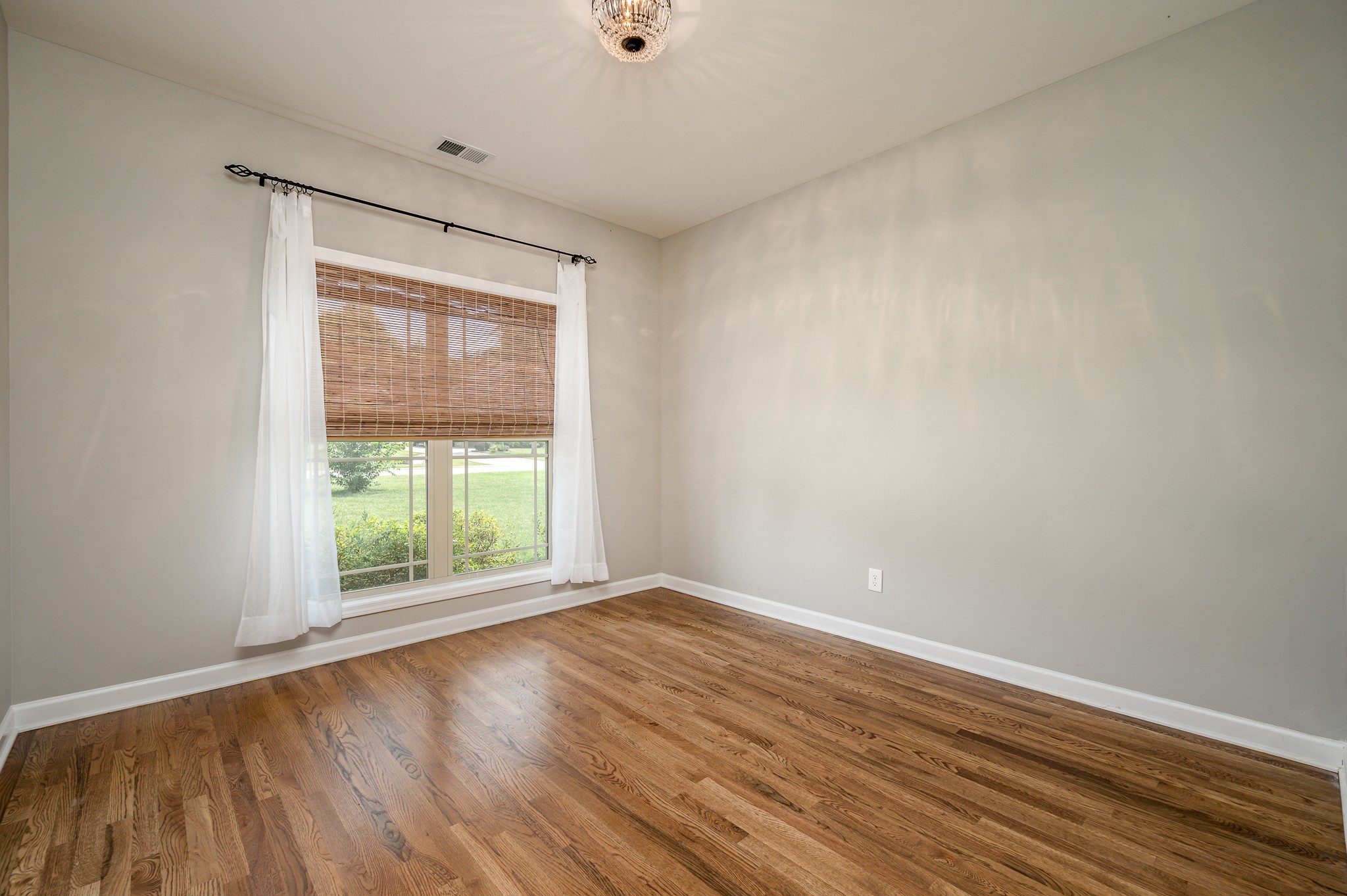 308 Amazonway Ridge Lascassas, TN 37085 - Photo 16 of 23 an empty room with wooden floor and windows
