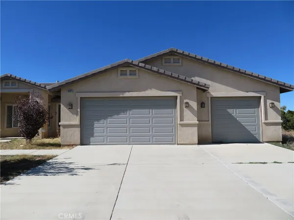 a front view of a house with a garage