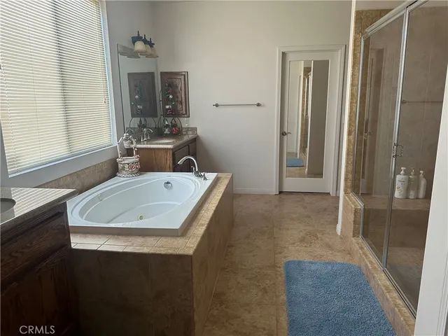 a bathroom with a sink a toilet a mirror and window