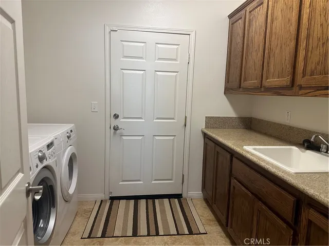 a utility room with a sink a washer and dryer